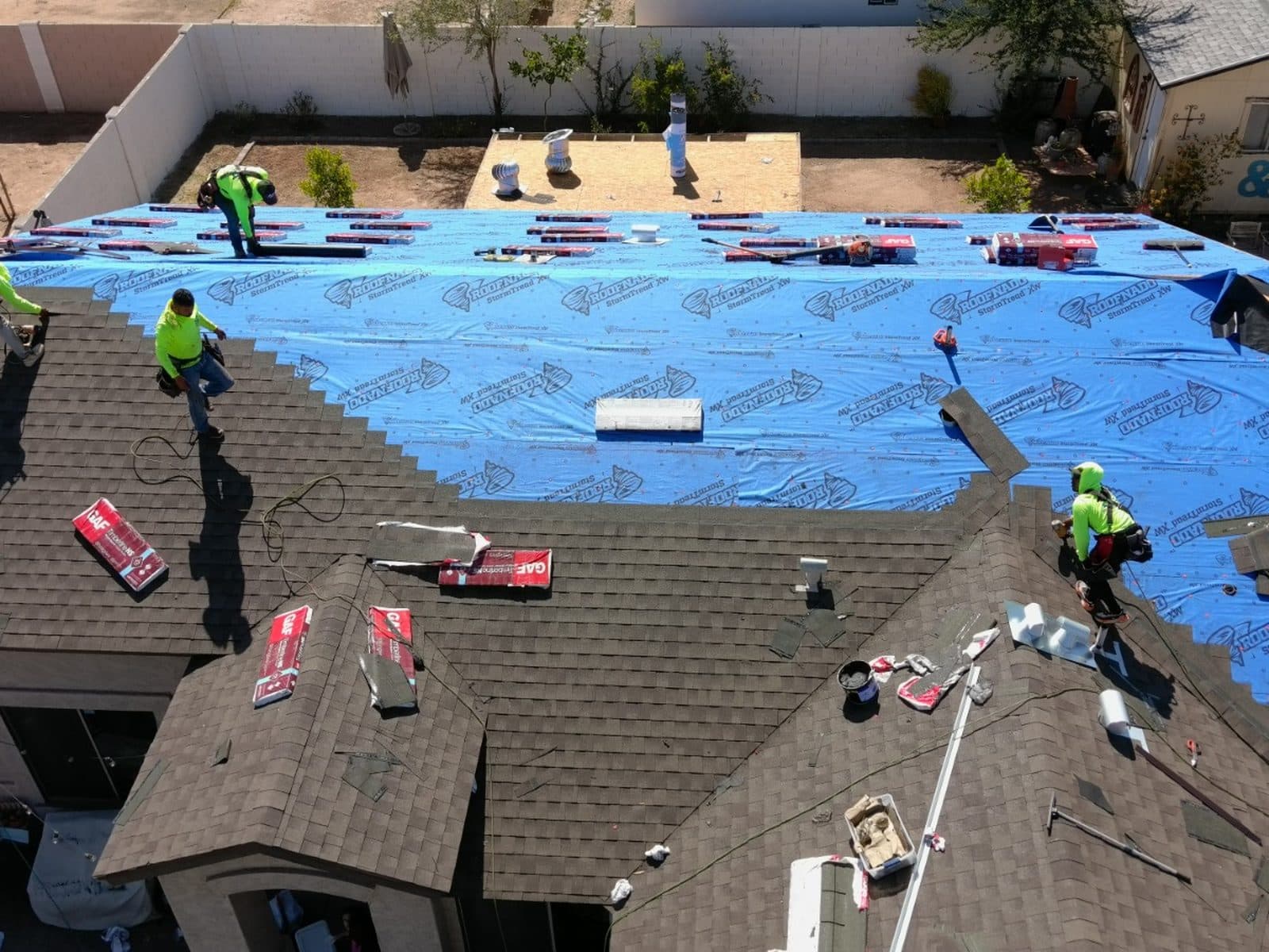 XRP Roofing crew installing new underlayment and shingles on a residential roof in the Phoenix area