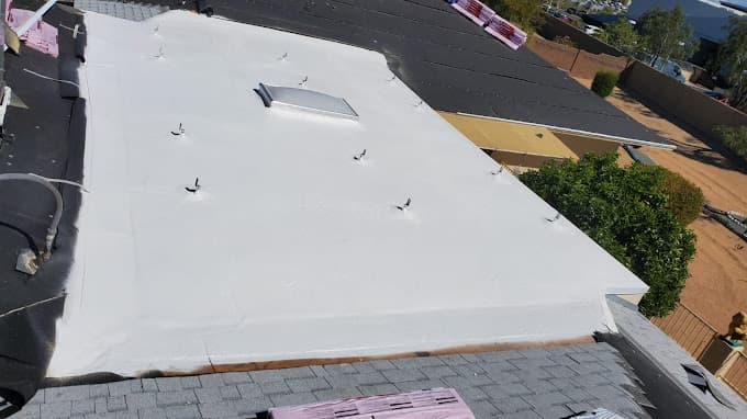 Roof repair work in progress on Phoenix home showing damaged sections