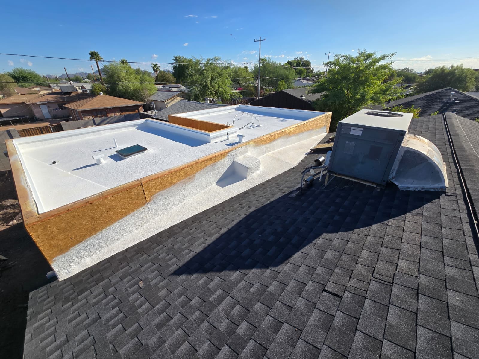 White foam roofing application on a Phoenix low slope roof by XRP Roofing